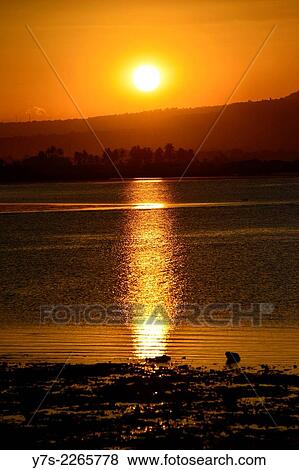 Stock Photo - Sunset in Sumbawa island, Indonesia, South East Asia.. Fotosearch