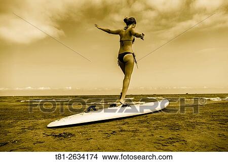 Picture - Surfboard girl in Benicasim, Castellon, Spain. Fotosearch
