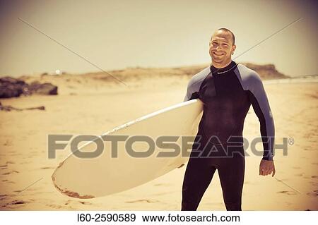 Surfer on the beach of El Cotillo, Fuerteventura, Canary Islands, Spain, Europe. View Large Photo Image Stock Photo - Surfer on the beach of El Cotillo, Fuerteventura, Canary Islands, Spain, Europe.. Fotosearch