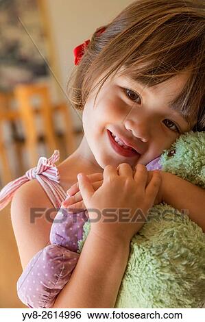 Sweet toddler girl holding her favorite toy. View Large Photo Image Stock Photograph - Sweet toddler girl holding her favorite toy.. Fotosearch