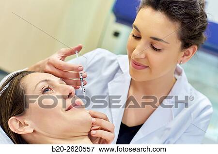 Syringe. Botox, cosmetic medicine. Botulinum toxin treatment involves injecting the toxin into specific parts of the muscles responsible for facial expression, getting that muscle paralysis and thus the disappearance of the wrinkle or crease occurs in mus View Large Photo Image Stock Photo - Syringe. Botox, cosmetic medicine. Botulinum toxin treatment involves injecting the toxin into specific parts of the muscles responsible for facial expression, getting that muscle paralysis and thus the disappearance of the wrinkle or crease occurs in mus. Fotosearch