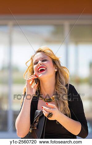 Talking on cellphone spontaneous View Large Photo Image Stock Image - Talking on cellphone spontaneous. Fotosearch