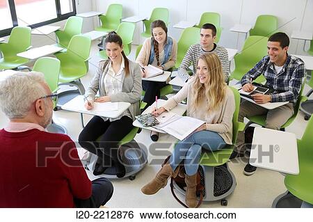 Teacher and young students at campus View Large Photo Image Stock Photograph - Teacher and young students at campus. Fotosearch