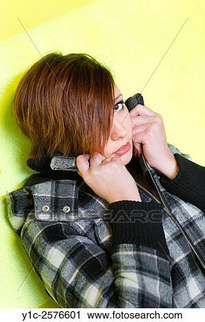 Stock Image - Teen girl is afraid hiding face. Fotosearch
