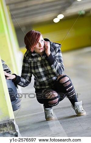 Stock Photo - Teen girl is wondering talking on cellphone. Fotosearch