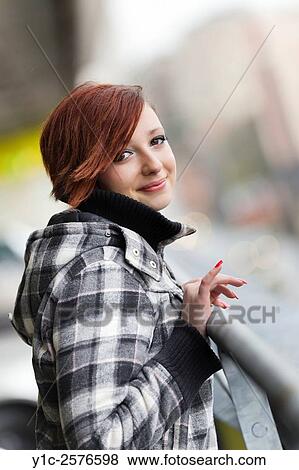 Teenager girl in jacket looking at camera with attention finger raised View Large Photo Image Stock Photo - Teenager girl in jacket looking at camera with attention finger raised. Fotosearch