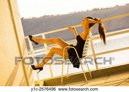 Teenager girl sitting enjoying warm sunset light View Large Photo Image Stock Photograph - Teenager girl sitting enjoying warm sunset light. Fotosearch