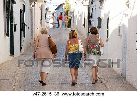 Three women walking through the streets of Altea, Altea, Alicante, Valencia, Spain, Europe View Large Photo Image Stock Photograph - Three women walking through the streets of Altea, Altea, Alicante, Valencia, Spain, Europe. Fotosearch