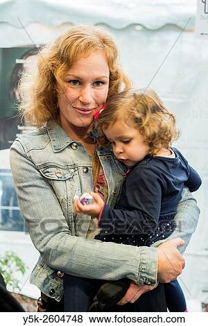 Tilburg, Netherlands. Dual portrait of a redheaded mother and her two year old toddle baby girl. View Large Photo Image Stock Photo - Tilburg, Netherlands. Dual portrait of a redheaded mother and her two year old toddle baby girl.. Fotosearch