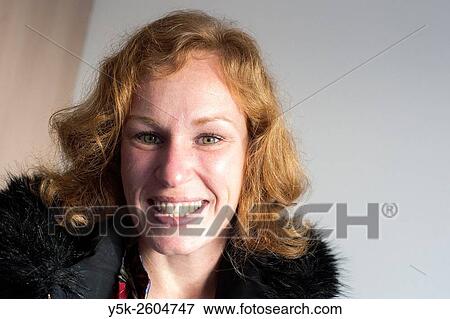Tilburg, Netherlands. Redheaded woman smiling, just after her visit to a Syrian refugee, who is learning the Dutch language. View Large Photo Image Stock Photo - Tilburg, Netherlands. Redheaded woman smiling, just after her visit to a Syrian refugee, who is learning the Dutch language.. Fotosearch