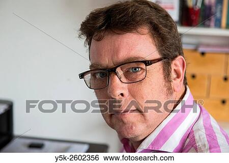 Tilburg, Netherlands. Side view portrait of a middle aged photographer working behind his studio desk. View Large Photo Image Stock Photograph - Tilburg, Netherlands. Side view portrait of a middle aged photographer working behind his studio desk.. Fotosearch