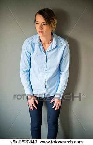 Tilburg, Netherlands. Studio shot of an attractive, blonde woman, leaning against the background wall. View Large Photo Image Stock Photo - Tilburg, Netherlands. Studio shot of an attractive, blonde woman, leaning against the background wall.. Fotosearch