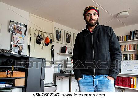 Tilburg, Netherlands. Syrian refugee to The Netherlands, in persue of becomming a photographer, visits a local photographer in his studio down town. View Large Photo Image Stock Photo - Tilburg, Netherlands. Syrian refugee to The Netherlands, in persue of becomming a photographer, visits a local photographer in his studio down town.. Fotosearch
