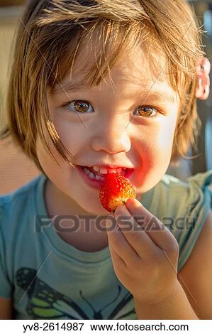 Toddler eating a strawberry. View Large Photo Image Stock Photo - Toddler eating a strawberry.. Fotosearch
