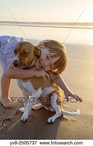 Toddler girl embracing her dog at the beach, La Jolla, California. View Large Photo Image Stock Photo - Toddler girl embracing her dog at the beach, La Jolla, California.. Fotosearch