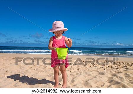 Toddler girl holding a green bucket at the beach, Kauai island. View Large Photo Image Stock Image - Toddler girl holding a green bucket at the beach, Kauai island.. Fotosearch