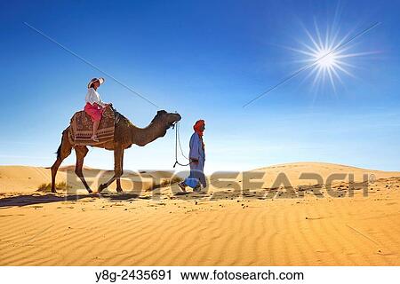 Tourist on camel ride, Erg Chebbi desert near Merzouga, Sahara, Morocco. View Large Photo Image Stock Image - Tourist on camel ride, Erg Chebbi desert near Merzouga, Sahara, Morocco.. Fotosearch