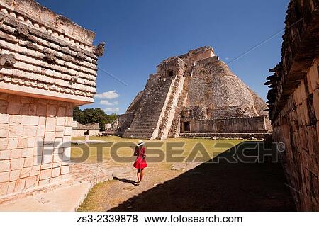 Tourist walking around the Pyramid of the Magician, Maya archeological site Uxmal, Yucatan, Mexico, Central America. View Large Photo Image Stock Photo - Tourist walking around the Pyramid of the Magician, Maya archeological site Uxmal, Yucatan, Mexico, Central America.. Fotosearch