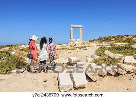 Tourists at the Temple of Apollo Arch, Naxos Island, Cyclades, Greece. View Large Photo Image Stock Photo - Tourists at the Temple of Apollo Arch, Naxos Island, Cyclades, Greece.. Fotosearch