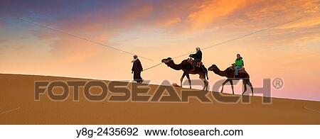 Tourists on camel ride, Erg Chebbi desert near Merzouga, Sahara, Morocco. View Large Photo Image Stock Image - Tourists on camel ride, Erg Chebbi desert near Merzouga, Sahara, Morocco.. Fotosearch