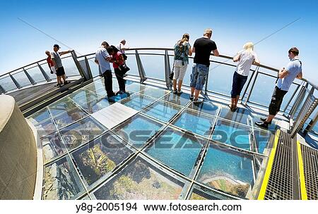 Tourists on the panoramic terrace (with glass floor) at the top of Cabo Girao (580 m highest) cliff - Camara de Lobos, Madeira, Portugal. View Large Photo Image Picture - Tourists on the panoramic terrace (with glass floor) at the top of Cabo Girao (580 m highest) cliff - Camara de Lobos, Madeira, Portugal.. Fotosearch