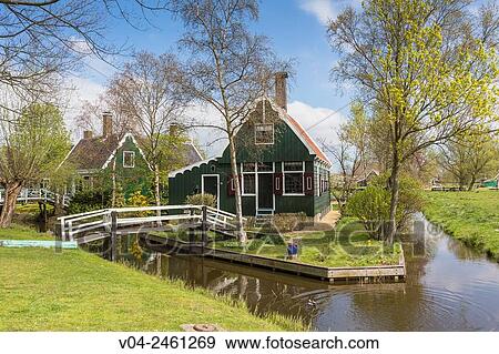Stock Photo - Traditional house, little canal and picturesque bridge in the historic village of Zaanse Schans, The Netherlands, Europe. Fotosearch