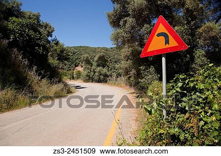 Stock Photo - Traffic sign indicating a curve, Rethymno Region, Crete, Greek Islands, Greece, Europe.. Fotosearch