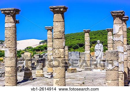 Trajan statue and Basilica at the Roman ruins of Baelo Claudia in Bolonia beach with sand dune in background. Tarifa, Cadiz, Andalusia, Spain. View Large Photo Image Picture - Trajan statue and Basilica at the Roman ruins of Baelo Claudia in Bolonia beach with sand dune in background. Tarifa, Cadiz, Andalusia, Spain.. Fotosearch
