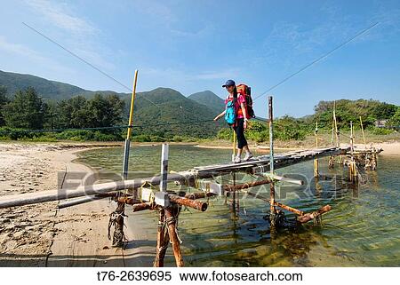 Stock Photography - Trekking on the MacLehose Trail above Ham Tin Wan beach, Sai Kung, Hong Kong.. Fotosearch