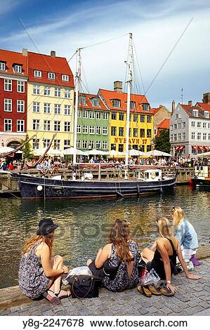 Turists resting at Nyhavn Canal, Copenhagen, Denmark. View Large Photo Image Stock Photo - Turists resting at Nyhavn Canal, Copenhagen, Denmark.. Fotosearch