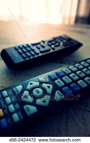 TV remotes on a table. View Large Photo Image Stock Image - TV remotes on a table.. Fotosearch