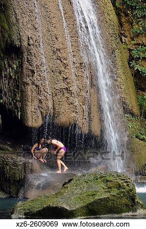 Two girs under a waterfall at Erawan National Park, Kanchanaburi, Thailand, Asia. View Large Photo Image Stock Photo - Two girs under a waterfall at Erawan National Park, Kanchanaburi, Thailand, Asia.. Fotosearch