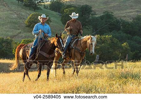 Stock Photography - Two wranglers (cowboys) on horses, California, USA. Fotosearch