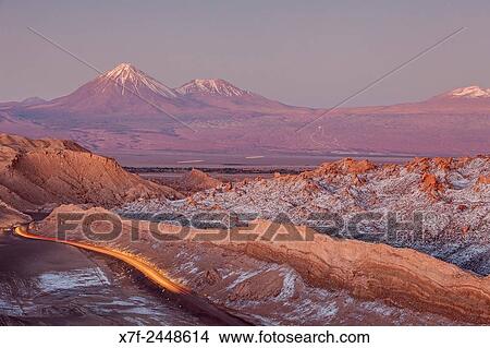 Valle de la Luna (Valley of the Moon ), in background at left volcanoes Licancabur and Juriques with snow on top, and salt deposited on the nearest mountains, Atacama desert. Region de Antofagasta. Chile. View Large Photo Image Picture - Valle de la Luna (Valley of the Moon ), in background at left volcanoes Licancabur and Juriques with snow on top, and salt deposited on the nearest mountains, Atacama desert. Region de Antofagasta. Chile.. Fotosearch