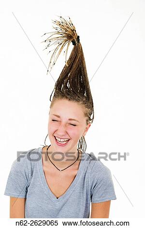 Very cheerful blonde girl laughs vigorously her tresses are raised vertically on her head. View Large Photo Image Stock Photography - Very cheerful blonde girl laughs vigorously her tresses are raised vertically on her head.. Fotosearch