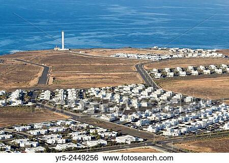 View over villas towards lighthouse at Playa Blanca, Lanzarote, Canary Islands, Spain. View Large Photo Image Stock Photograph - View over villas towards lighthouse at Playa Blanca, Lanzarote, Canary Islands, Spain.. Fotosearch