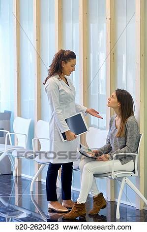Waiting room. Doctor attending to patient medical consultation. Tablet. Office. View Large Photo Image Stock Image - Waiting room. Doctor attending to patient medical consultation. Tablet. Office.. Fotosearch