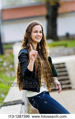 Warning with a finger smiling young woman View Large Photo Image Stock Photograph - Warning with a finger smiling young woman. Fotosearch