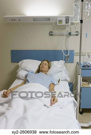 Woman, 35-40 years old, sedated and lying in hospital bed after operation. View Large Photo Image Stock Photo - Woman, 35-40 years old, sedated and lying in hospital bed after operation.. Fotosearch