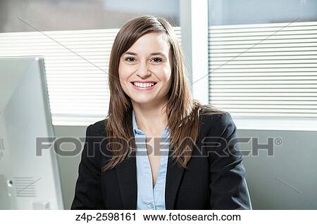Woman in offic smiling at camera View Large Photo Image Stock Image - Woman in offic smiling at camera. Fotosearch