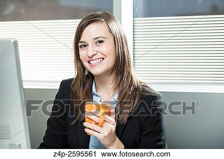 Woman in office with coffee looking at camera. View Large Photo Image Stock Image - Woman in office with coffee looking at camera.. Fotosearch
