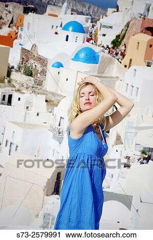 Stock Image - Woman in Oia, Santorini, Cyclades Islands, Greece. Fotosearch
