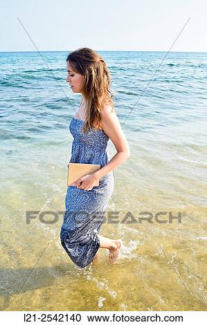 Stock Image - Woman on the beach. Fotosearch