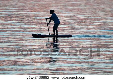 Woman paddling on Port Phillip Bay at sunset, Melbourne. View Large Photo Image Stock Image - Woman paddling on Port Phillip Bay at sunset, Melbourne.. Fotosearch