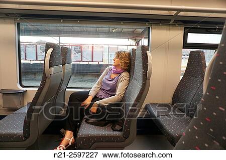 Woman sleeping on the Antwerp-Brussels train. Belgium, Europe. View Large Photo Image Stock Photo - Woman sleeping on the Antwerp-Brussels train. Belgium, Europe.. Fotosearch