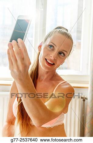 Woman taking a selfie View Large Photo Image Stock Image - Woman taking a selfie. Fotosearch