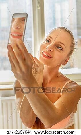 Woman taking a selfie View Large Photo Image Stock Image - Woman taking a selfie. Fotosearch