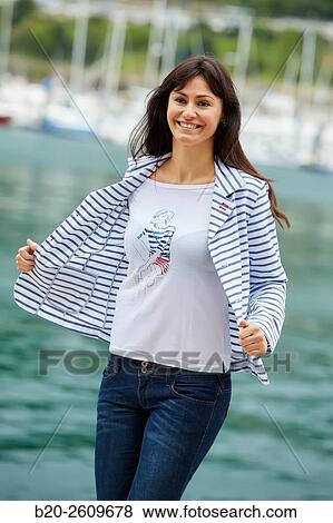 Stock Photo - Woman walking in the marina. Port. Getaria. Gipuzkoa. Basque Country. Spain. Fotosearch
