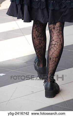 Woman wearing black cobweb design tights walking in street road in city town View Large Photo Image Stock Image - Woman wearing black cobweb design tights walking in street road in city town. Fotosearch
