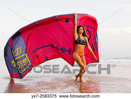 Woman with a kitesurf at the beach. Tarifa, Costa de la Luz, Cadiz, Andalusia, Southern Spain. View Large Photo Image Stock Photography - Woman with a kitesurf at the beach. Tarifa, Costa de la Luz, Cadiz, Andalusia, Southern Spain.. Fotosearch